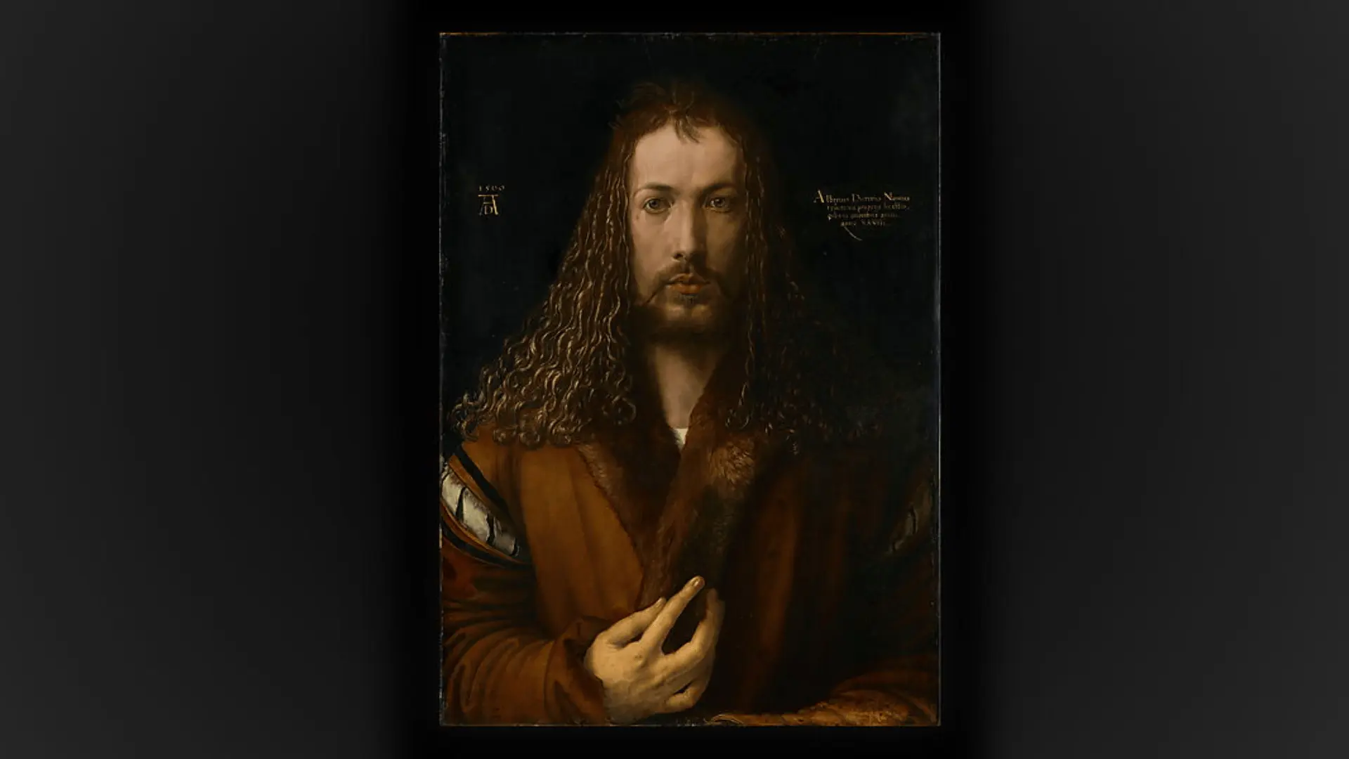 Albrecht Dürer’s self-portrait shows a man with long hair and a beard, wearing a luxurious fur-trimmed robe.