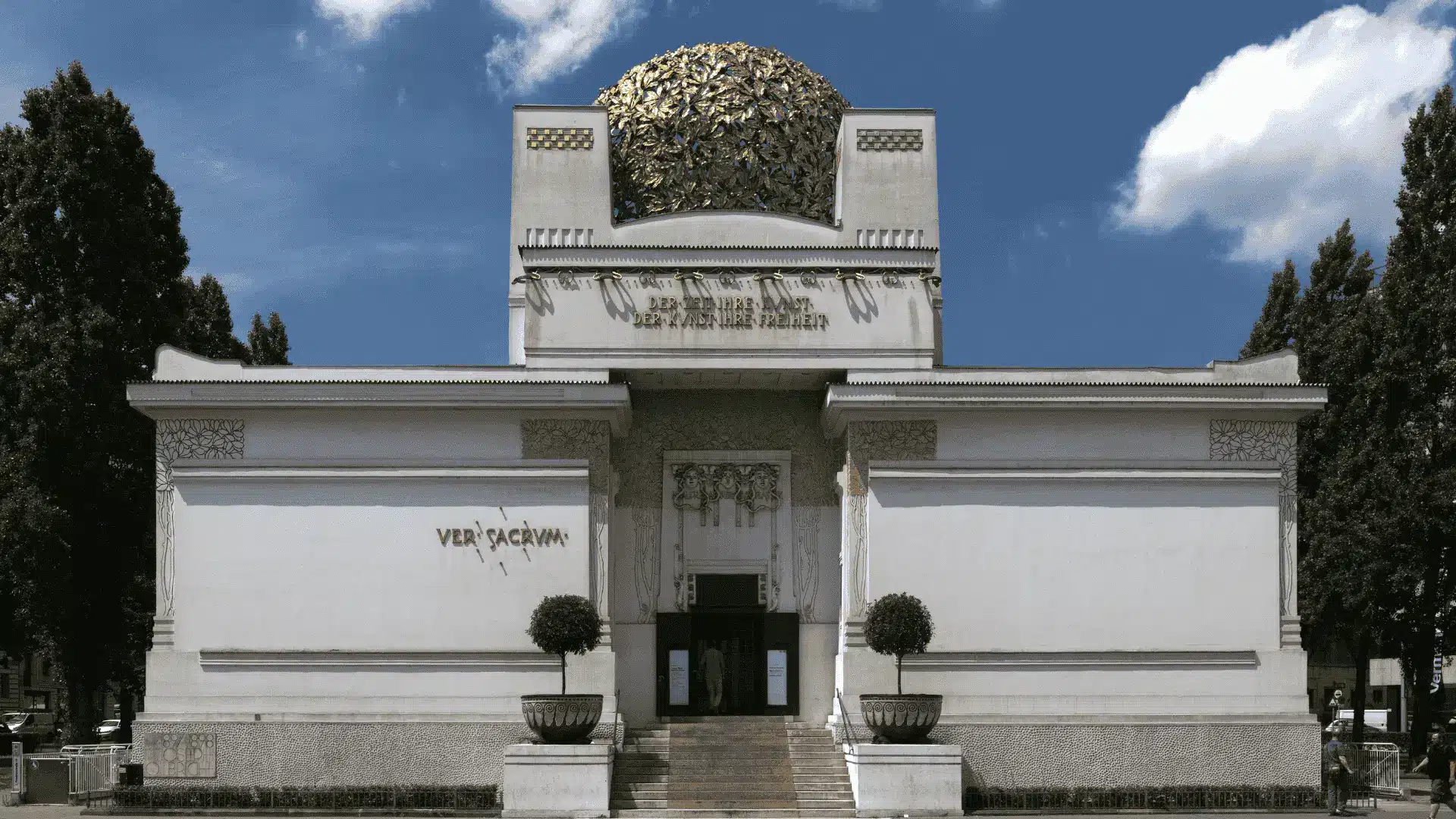 White Secession Building in Vienna, featuring a prominent gold dome, showcasing European architectural style.