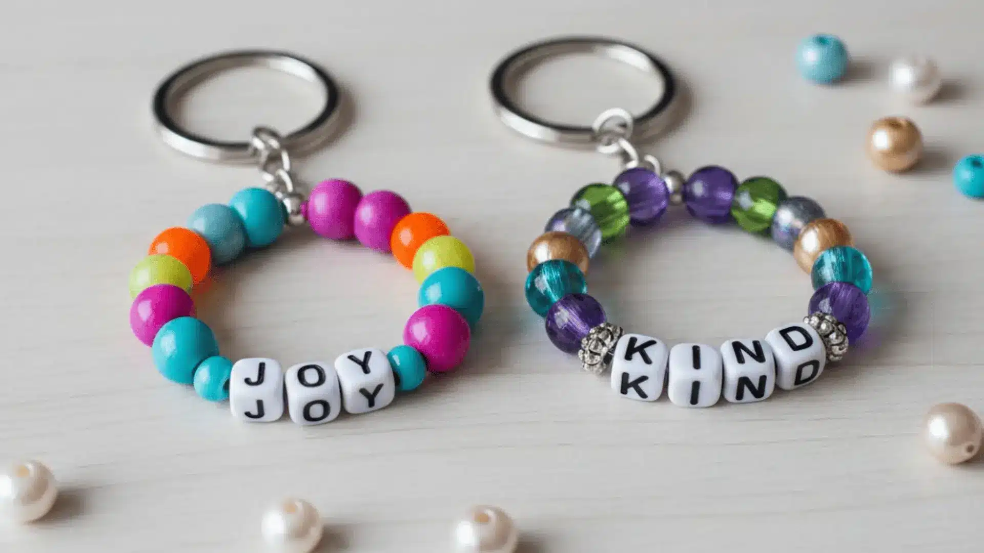 Colourful bead keychains with bright beads and positive word patterns.