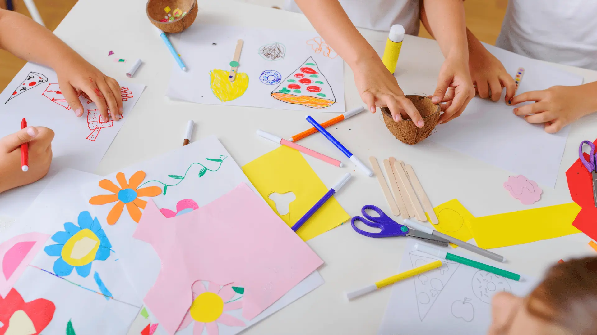 A close-up of children's hands using scissors and paper, showcasing engaging emotional regulation activities for kids.