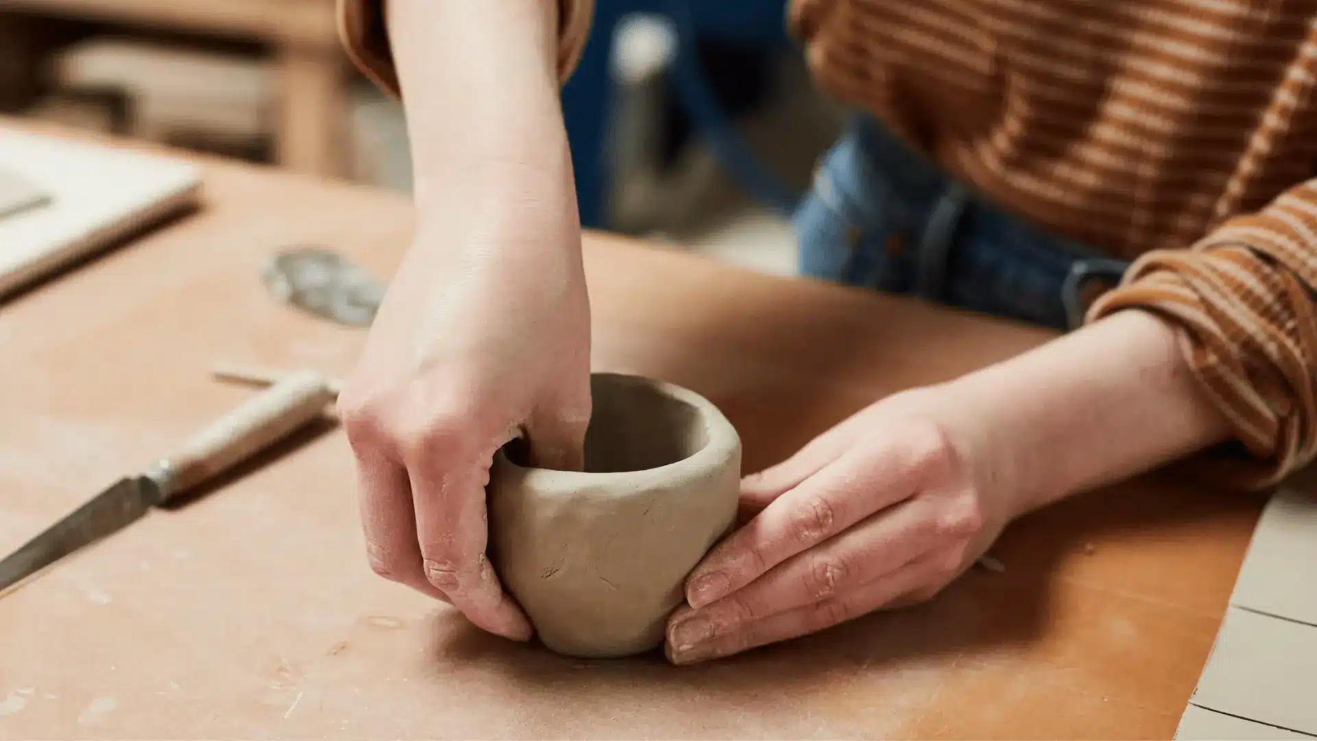 pinch pot method being used in clay building