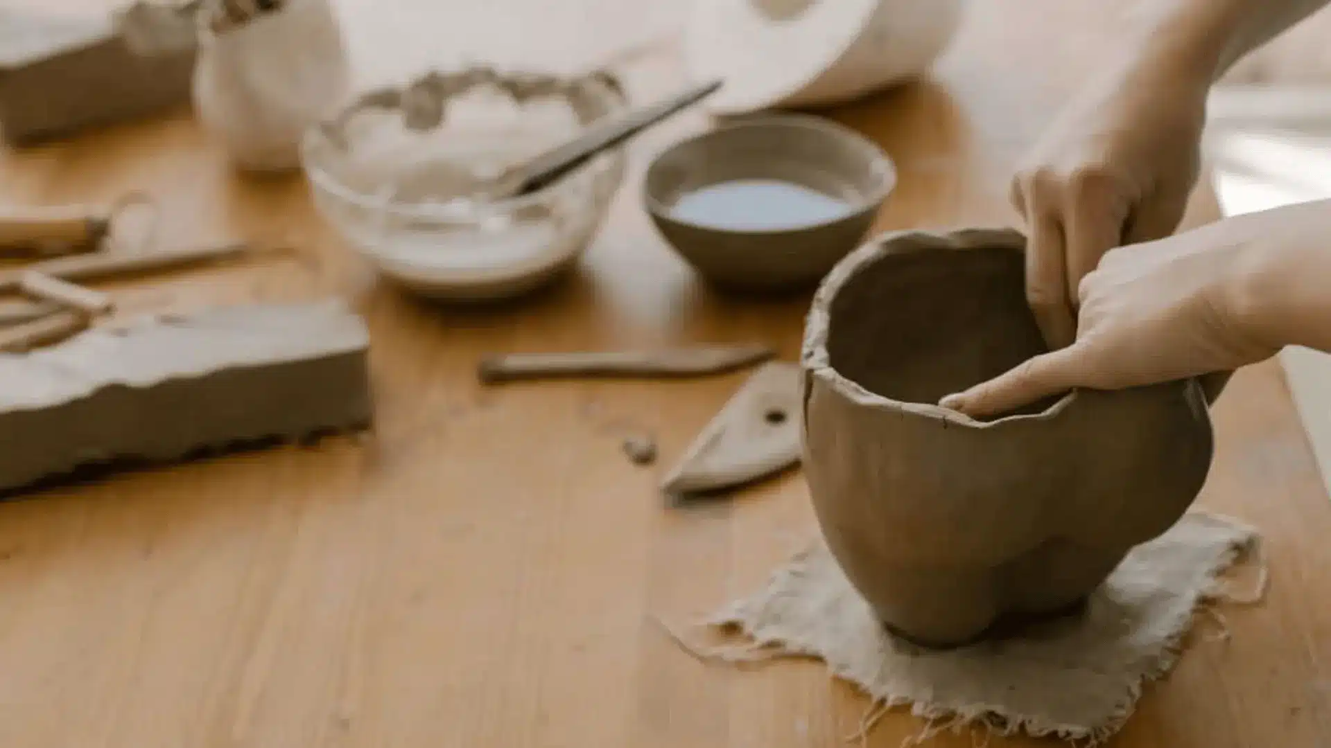 a person using pushing out forms in pottery 