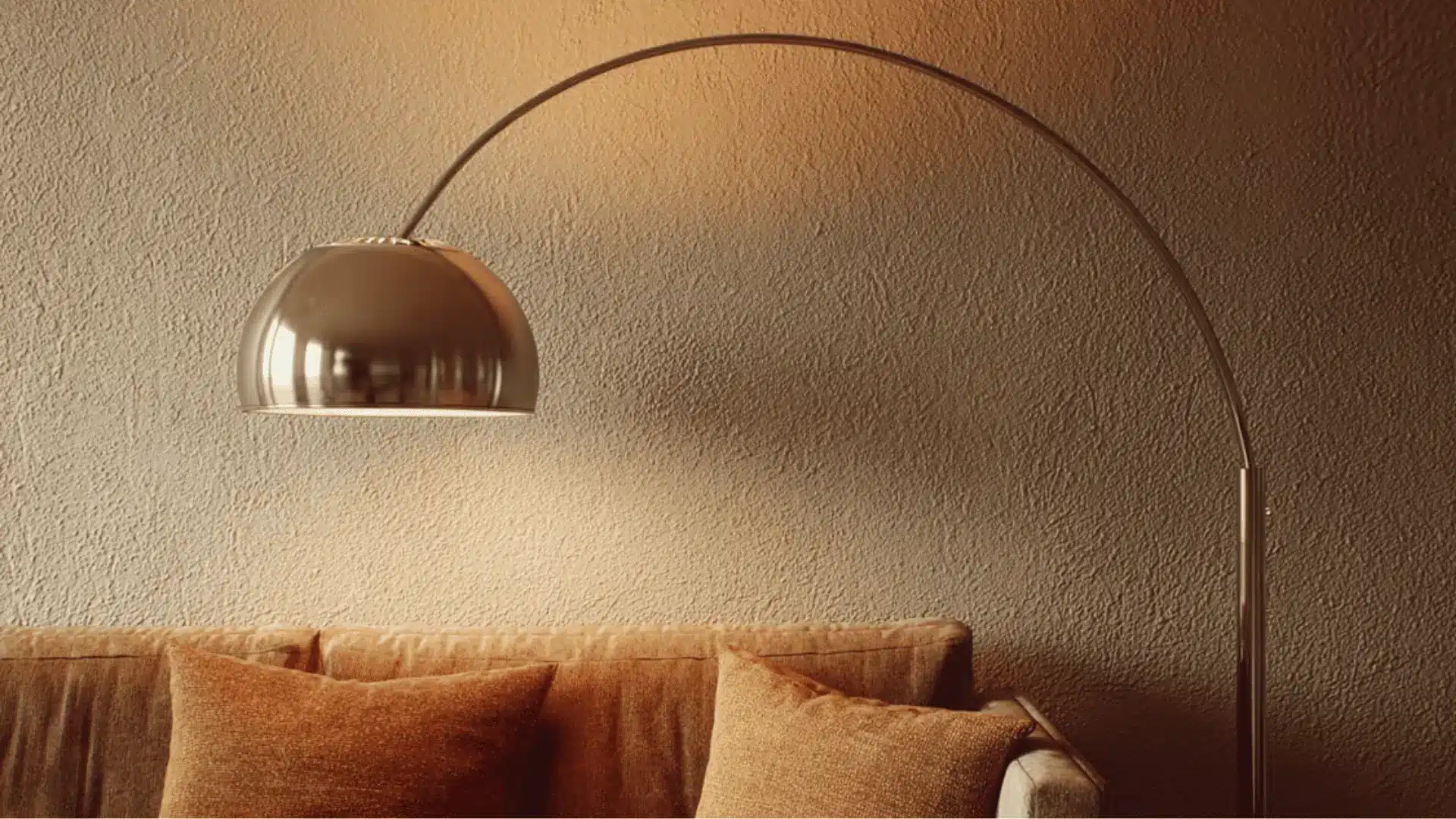 an arc floor lamp illuminating a retro-style sofa corner.