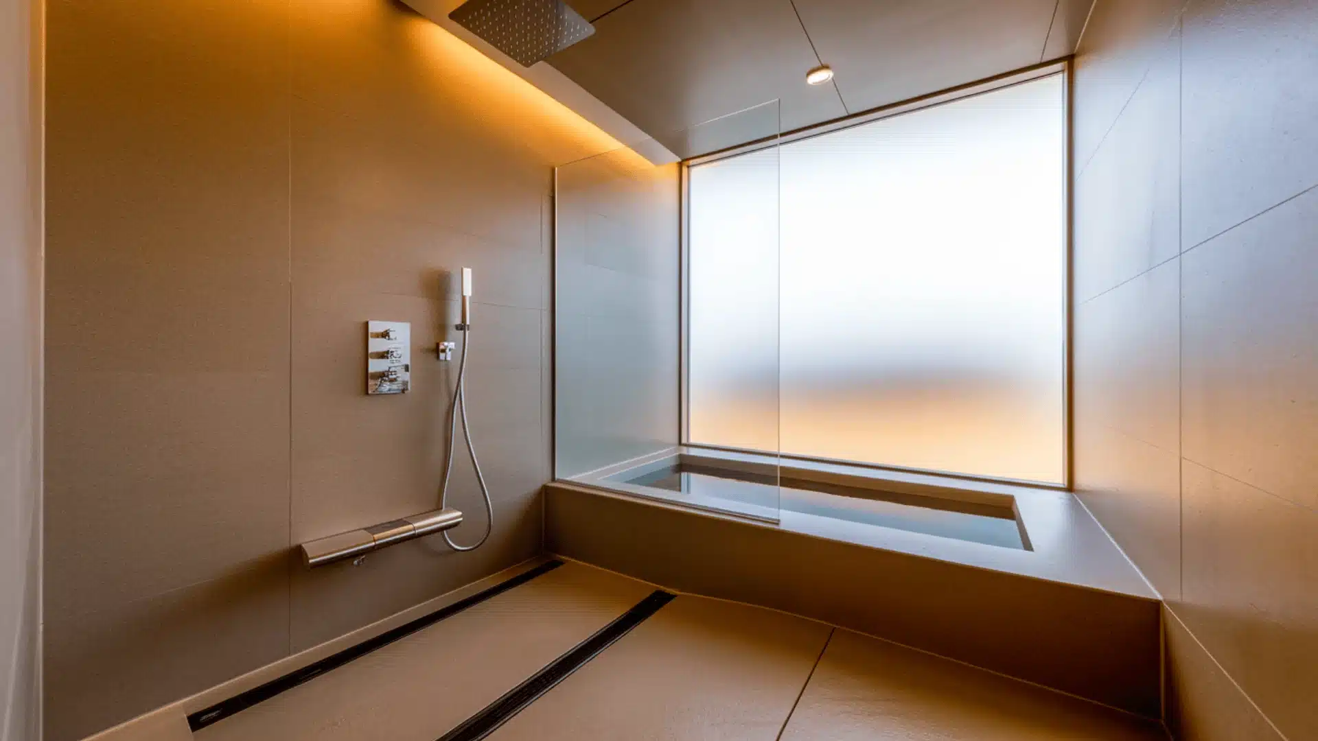 Shower beside soaking tub in Japanese bathroom.