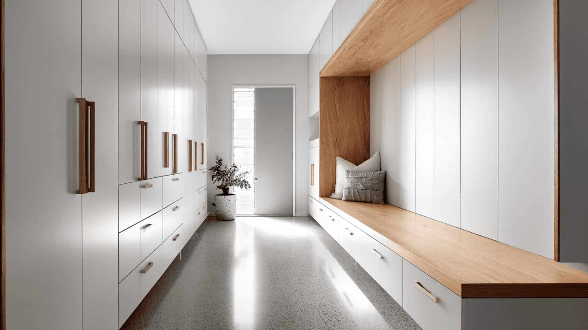 Modern mudroom with sleek pull-out shoe drawers and hidden storage cabinets
