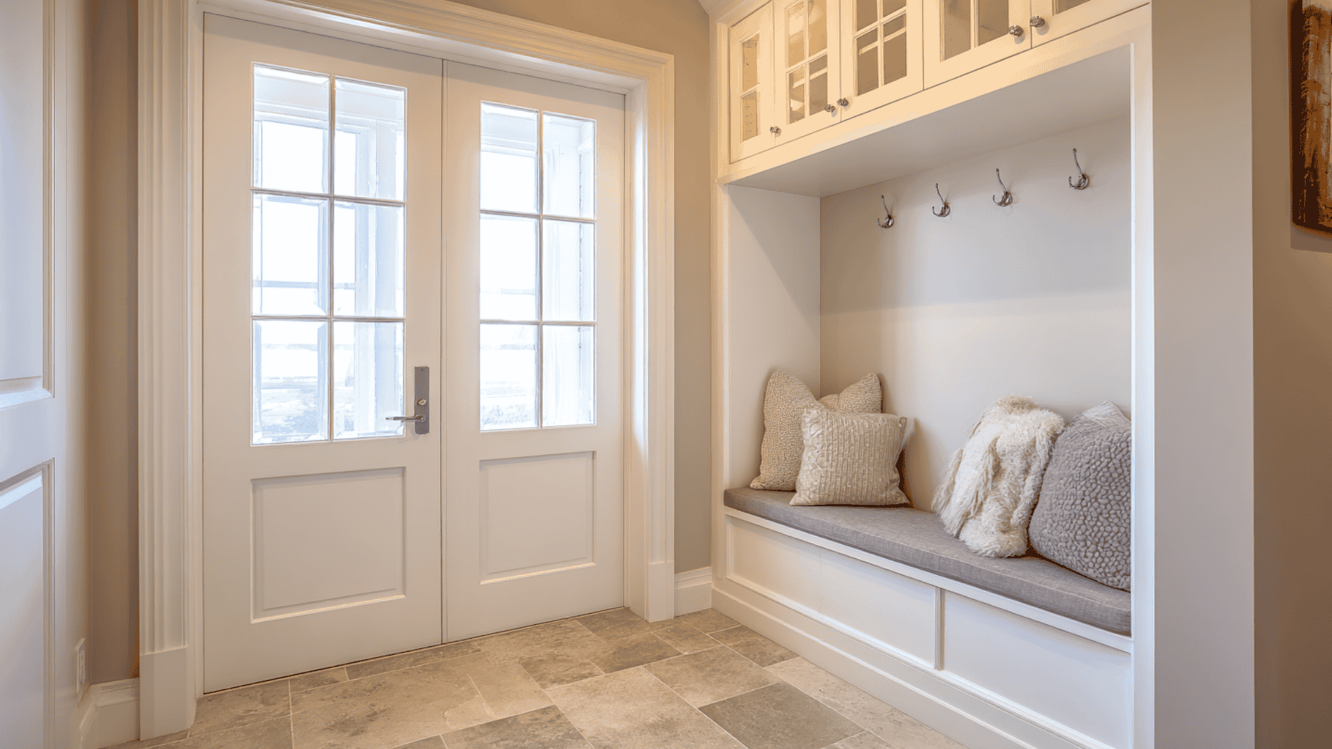 Two-door mudroom with bench and durable flooring for better dirt control
