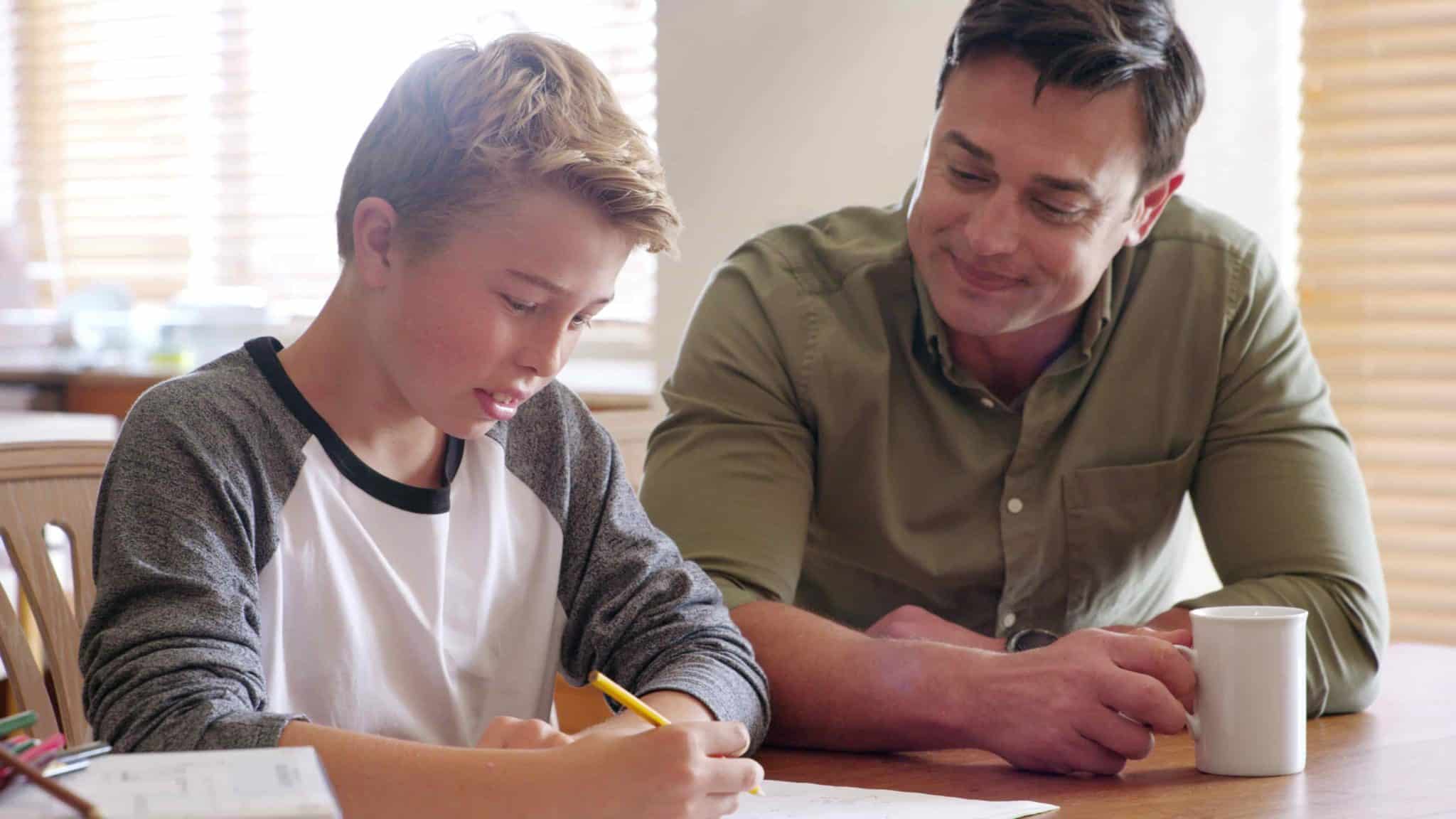 boy sitting with his dad at the table