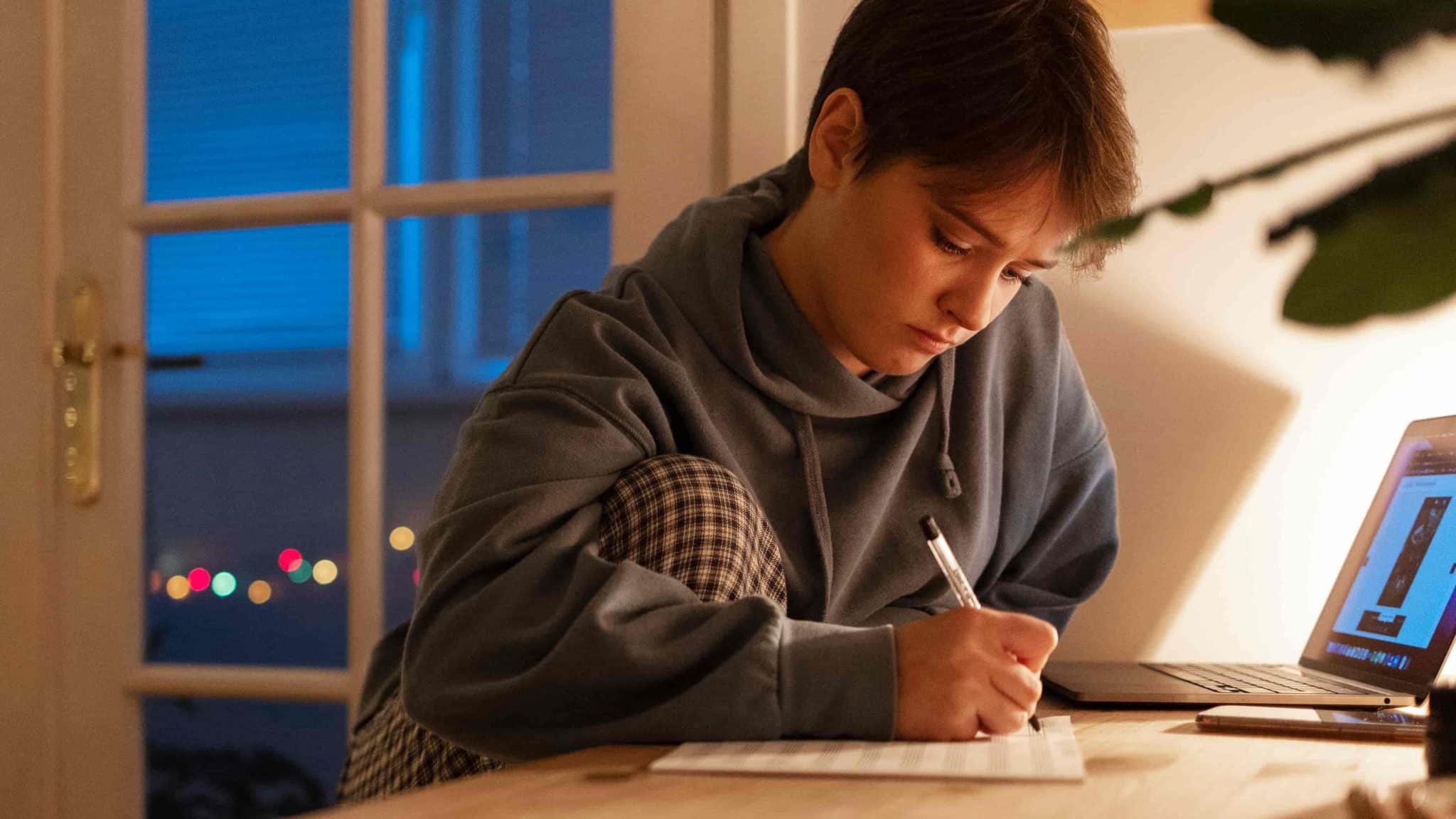A teenager thinking while holding a diary in her hands
