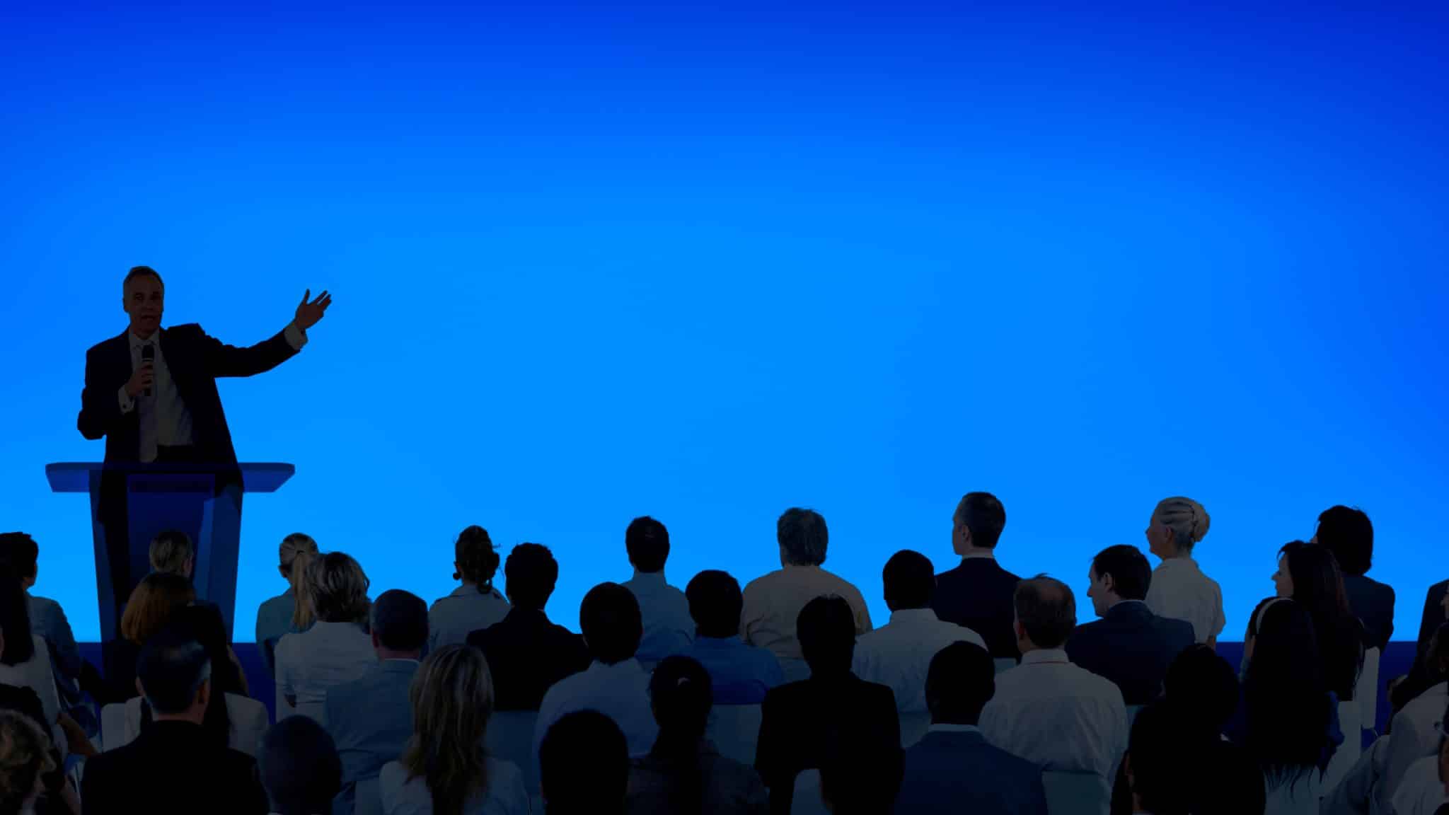 Student speaking on stage during a school mental health awareness assembly
