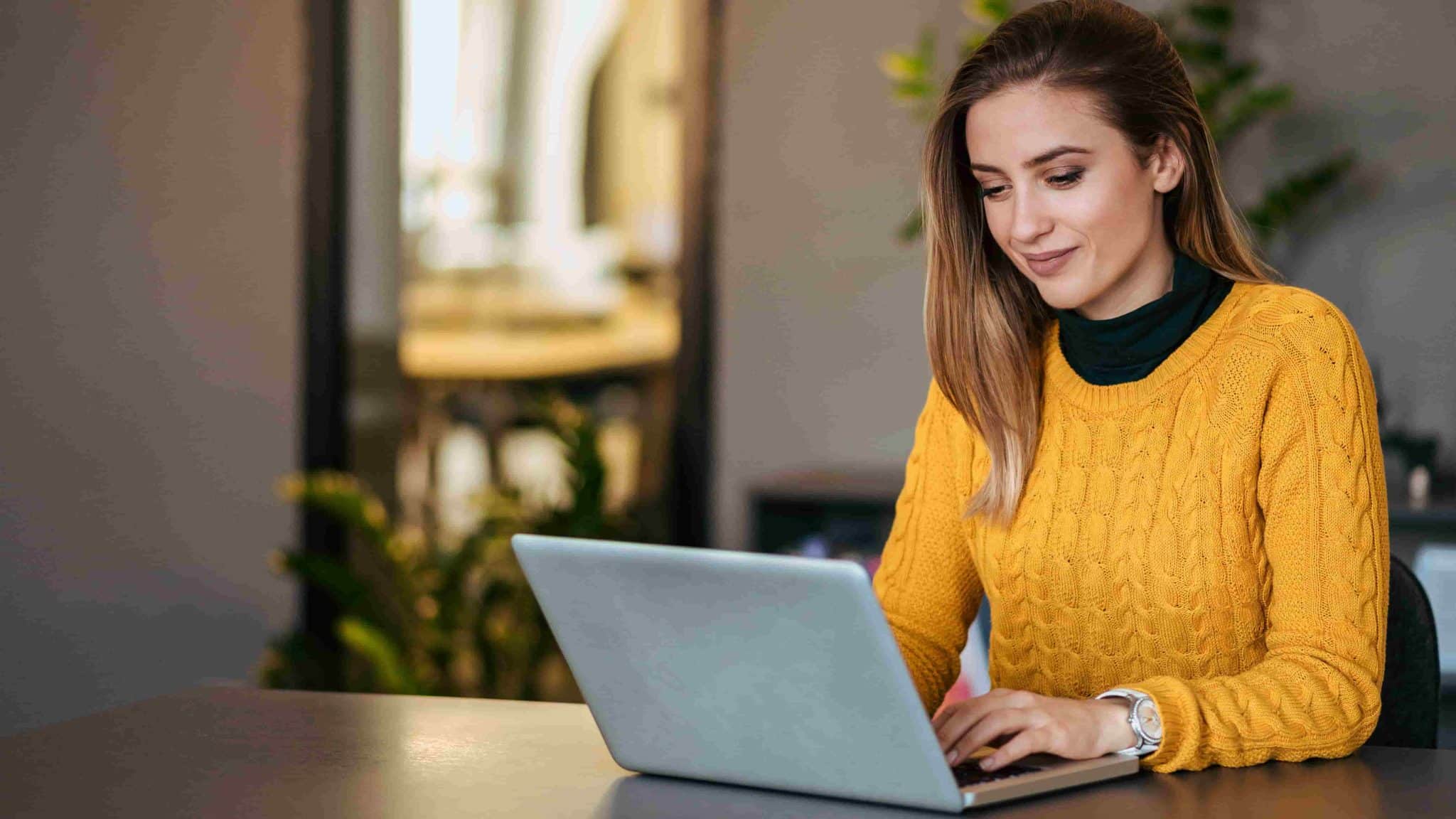 Employee completing an anonymous mental health survey on a laptop at a desk