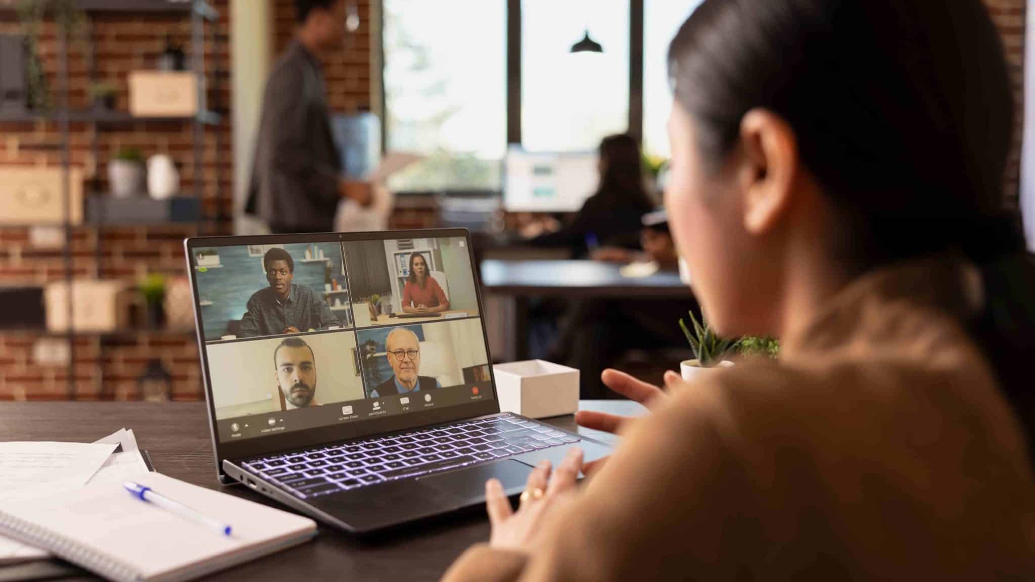 Person attending an online mental health support group session on a laptop
